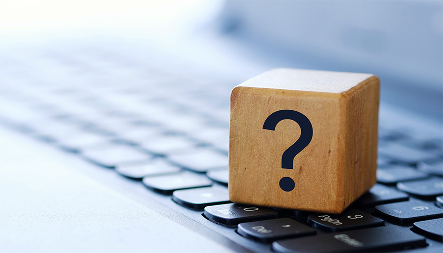 Diversified Tag and Title Services Resources page image of question block on laptop keyboard.
